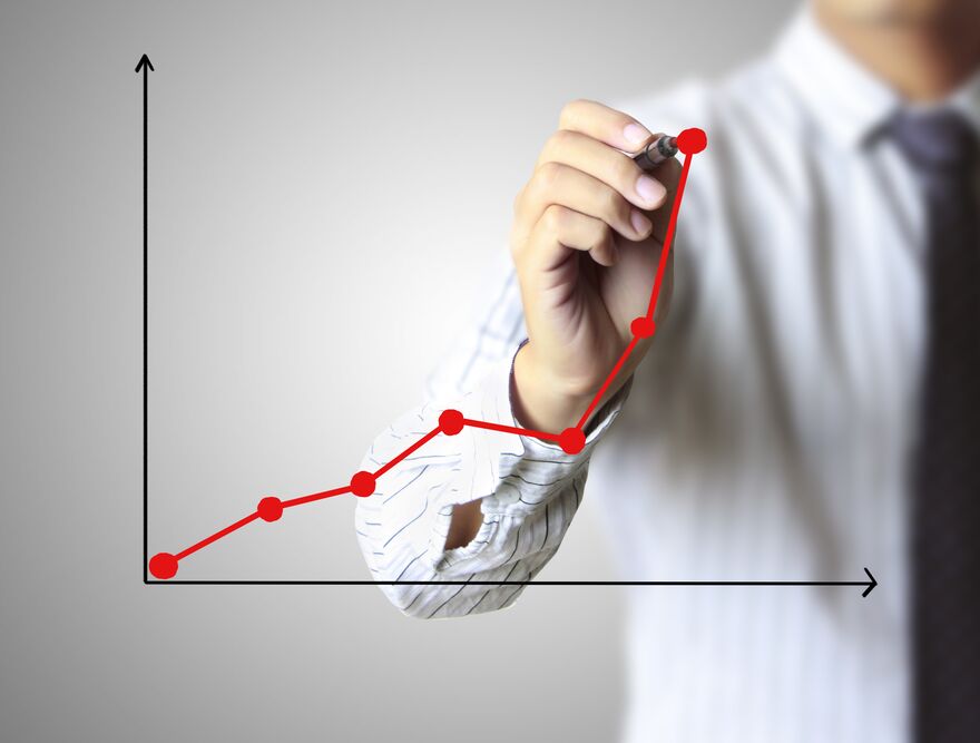 A hand drawing an ascending growth curve, suggesting long-term passive allocation.