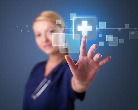 A clinician interacting with a glowing medical-cross UI element.