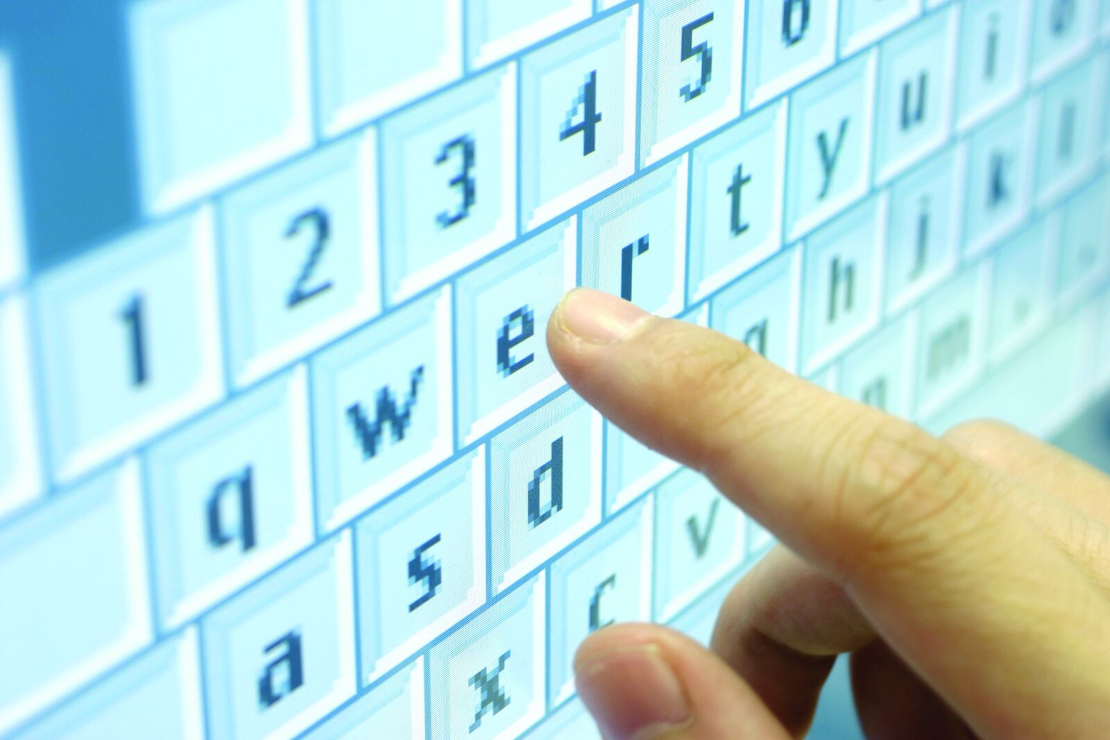 A finger pressing a virtual key on a translucent touchscreen — direct-contact motif.